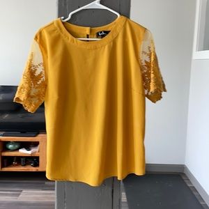 Lulus mustard color top with lace sleeves.